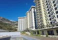 Kupić Nieruchomość w Alanyi z widokiem na morze - apartament 1+1 w Mahmutlar 4 