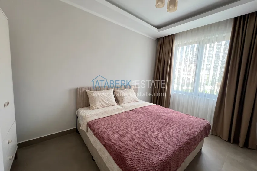 Kupuj  Wykończony apartament z dwiema sypialniami w kompleksie w budowie w Mahmutlar 15 