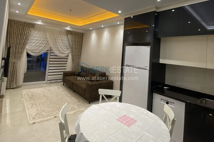 Kupuj  1+1 mieszkanie 70 m² w centrum Mahmutlar — umeblowane, przeszklony balkon, raty do 1 roku 2 