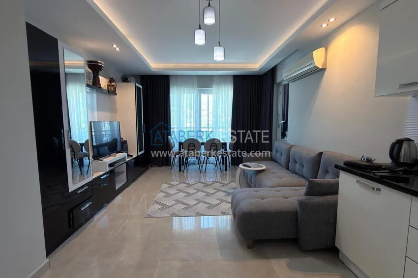 Kupuj Apartament 1+1 w centrum Mahmutlar - na 12. piętrze z meblami i widokiem na góry 1