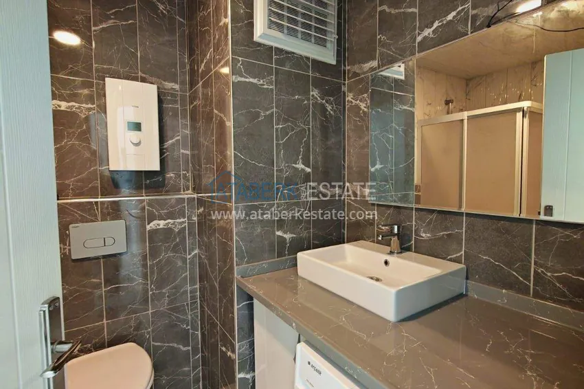 Kupuj  Nieruchomość w Alanyi z licencją na wynajem krótkoterminowy - apartament 1+1 w Avsallar 12 